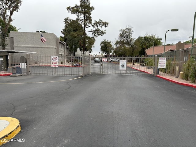 4554 E Paradise Village Pkwy N Unit 249, Phoenix, AZ 85032 - view of road with a gate, a gated entry, and curbs