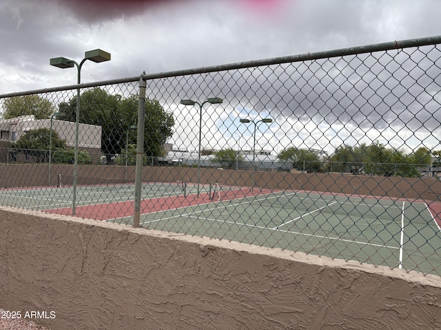 4554 E Paradise Village Pkwy N Unit 249, Phoenix, AZ 85032 - view of tennis court with community basketball court and fence
