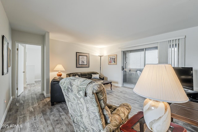 4554 E Paradise Village Pkwy N Unit 249, Phoenix, AZ 85032 - living room featuring baseboards and wood finished floors