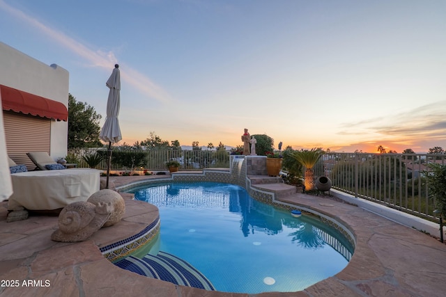 pool at dusk with a fenced backyard, a fenced in pool, and a patio