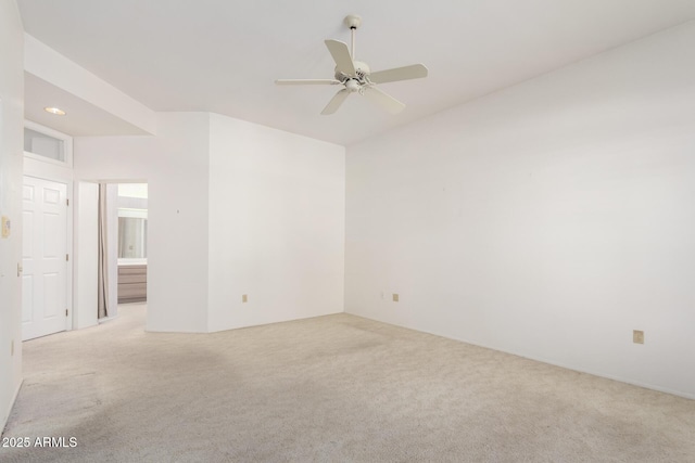 unfurnished room featuring light carpet and ceiling fan