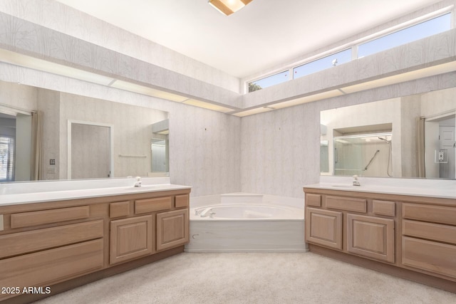 bathroom with vanity and shower with separate bathtub