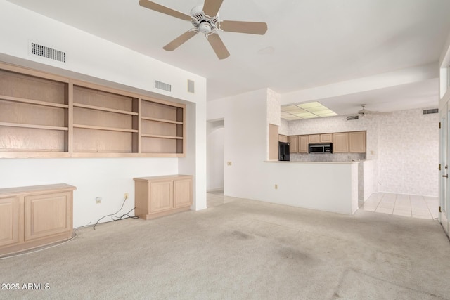 unfurnished living room featuring light carpet and ceiling fan