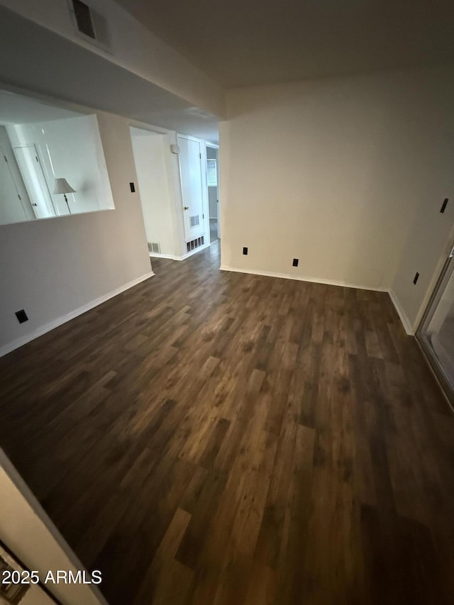 5517 E Boise St, Mesa, AZ 85205 - unfurnished living room with dark wood-type flooring and baseboards