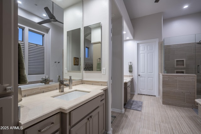 bathroom featuring walk in shower, ceiling fan, and vanity