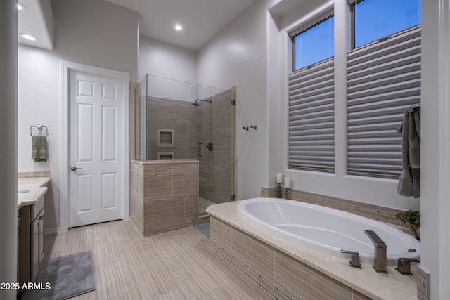 bathroom featuring plus walk in shower and vanity