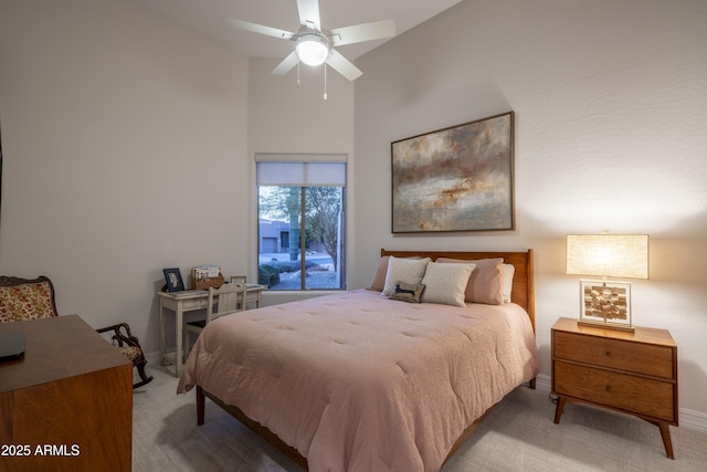 bedroom featuring light carpet, vaulted ceiling, and ceiling fan