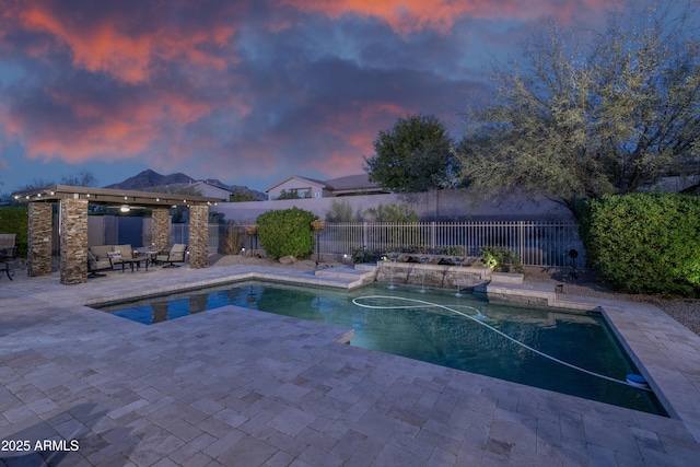 pool at dusk featuring a patio area