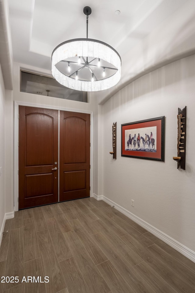 entrance foyer featuring a notable chandelier and dark wood-type flooring