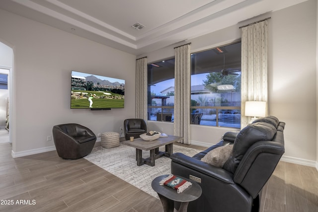 living room with a tray ceiling