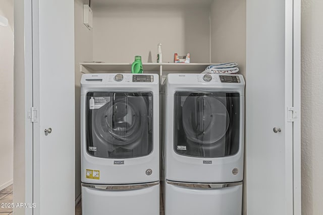 laundry area with separate washer and dryer and laundry area