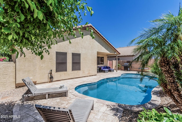 view of swimming pool with outdoor lounge area, a fenced backyard, area for grilling, a fenced in pool, and a patio area