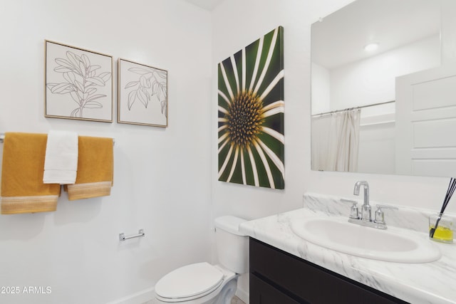 bathroom featuring vanity, toilet, and a shower with shower curtain