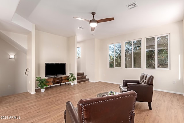 living room with ceiling fan and light hardwood / wood-style flooring