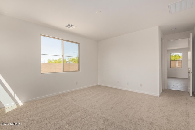 12358 W Marguerite Ave, Avondale, AZ 85323 - empty room featuring visible vents, baseboards, and light carpet