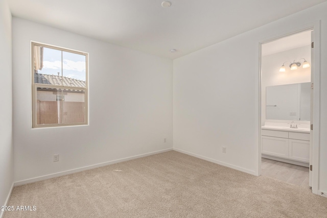 12358 W Marguerite Ave, Avondale, AZ 85323 - unfurnished bedroom featuring ensuite bathroom, baseboards, and light colored carpet