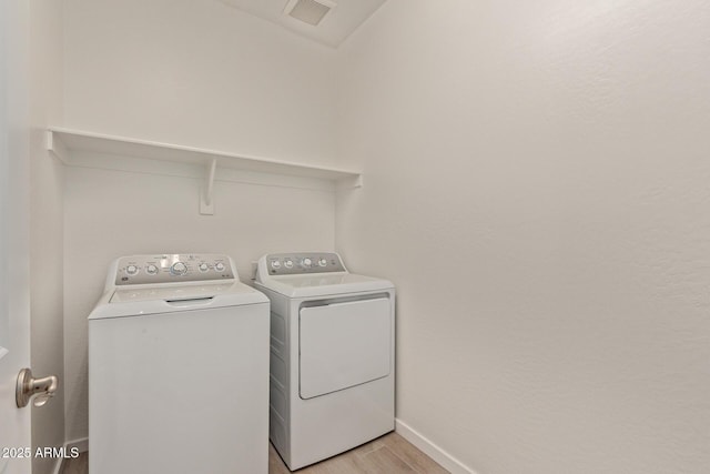 12358 W Marguerite Ave, Avondale, AZ 85323 - laundry area featuring laundry area, visible vents, independent washer and dryer, light wood-type flooring, and baseboards
