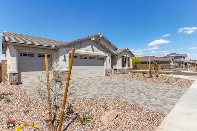 12358 W Marguerite Ave, Avondale, AZ 85323 - single story home featuring stucco siding, an attached garage, a tile roof, decorative driveway, and stone siding