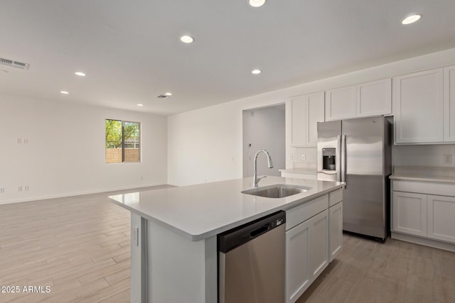 12358 W Marguerite Ave, Avondale, AZ 85323 - kitchen featuring light wood finished floors, a sink, visible vents, light countertops, and appliances with stainless steel finishes