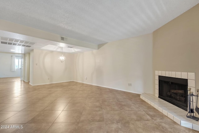 unfurnished living room featuring light tile patterned floors and a textured ceiling