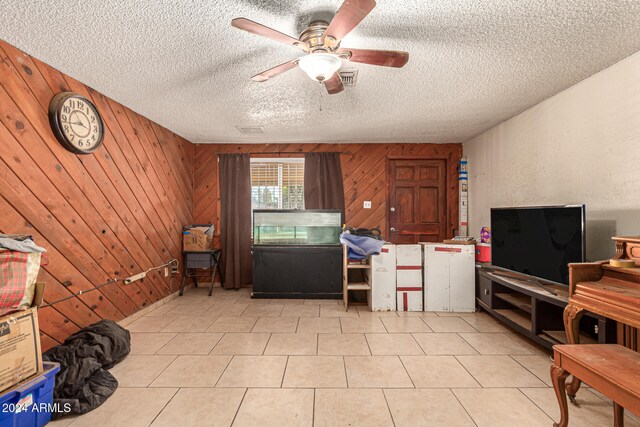 kitchen featuring wood walls and a textured ceiling