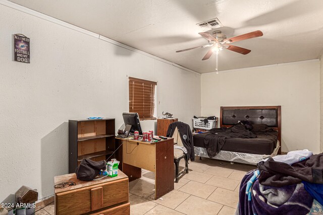 tiled bedroom with ceiling fan and crown molding