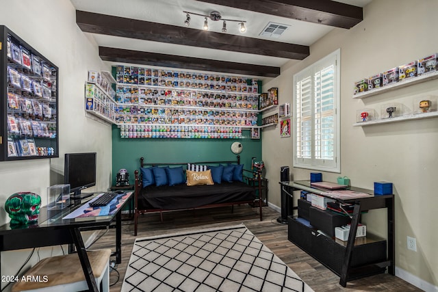 bedroom with beamed ceiling and hardwood / wood-style flooring