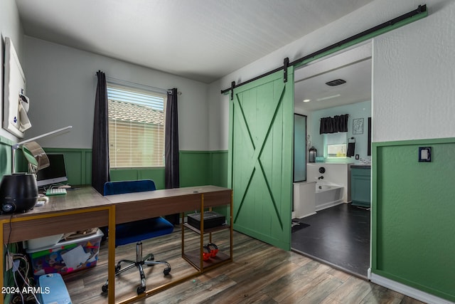 office area featuring dark hardwood / wood-style flooring and a barn door