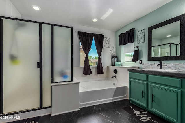 bathroom featuring independent shower and bath, backsplash, and vanity