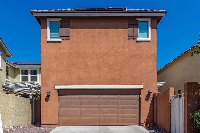 view of front of house featuring a garage and a pergola