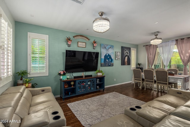 living room featuring dark hardwood / wood-style floors and a notable chandelier