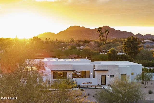 view of front of property with a mountain view and stucco siding