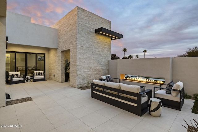 patio terrace at dusk with an outdoor living space