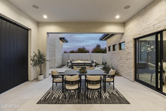 tiled dining space with recessed lighting