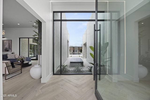 interior space with expansive windows, baseboards, and a healthy amount of sunlight