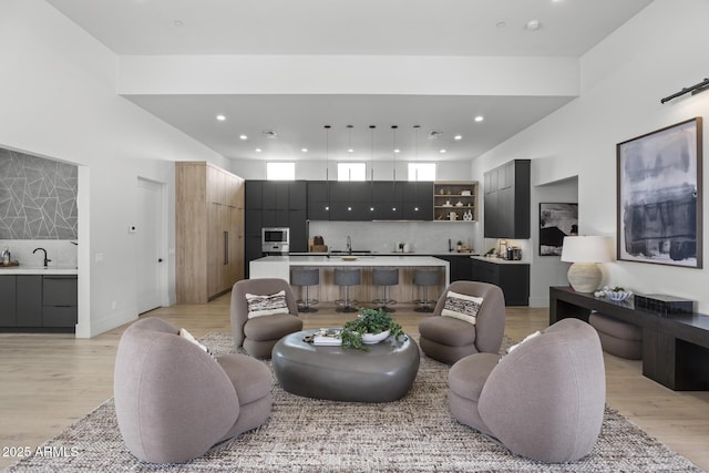 living area with recessed lighting and light wood-type flooring