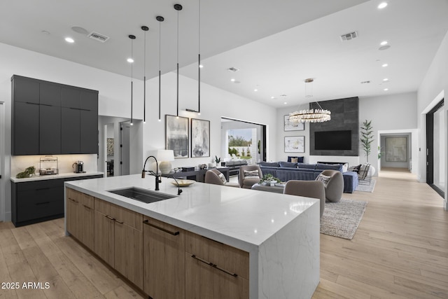 kitchen with visible vents, a sink, and modern cabinets