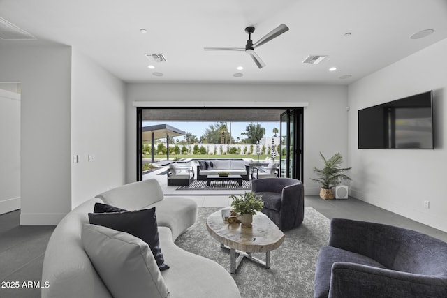 living room with a ceiling fan, visible vents, and a wealth of natural light