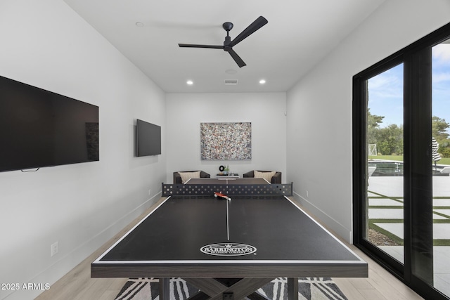 playroom with baseboards, ceiling fan, visible vents, and wood finished floors