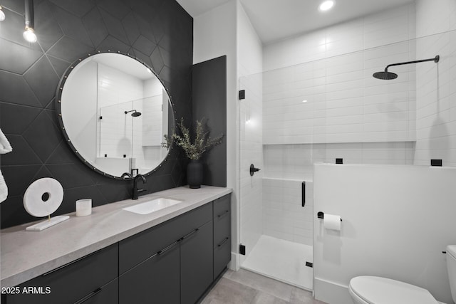 bathroom with vanity, a stall shower, and toilet