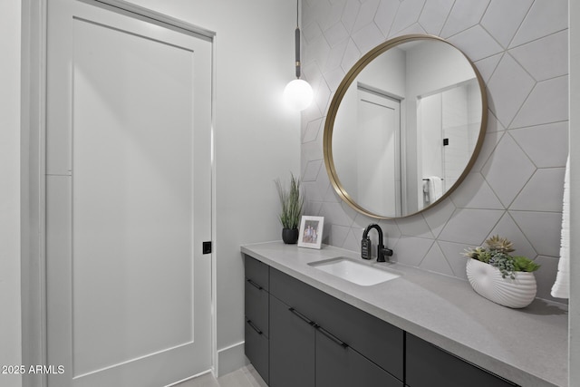 bathroom featuring vanity and tasteful backsplash