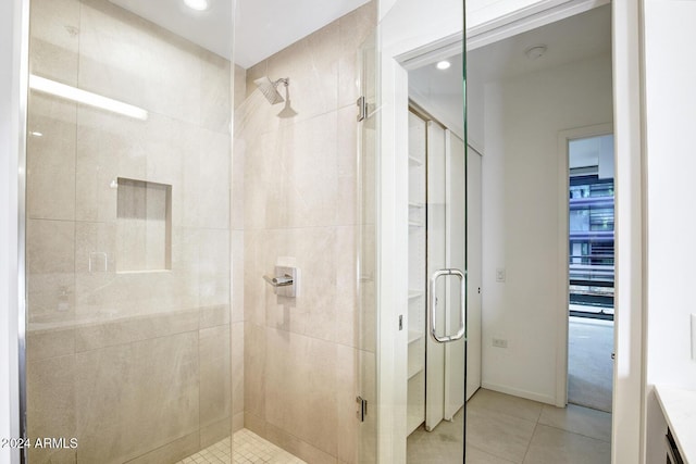 bathroom featuring tile patterned flooring and a shower with door