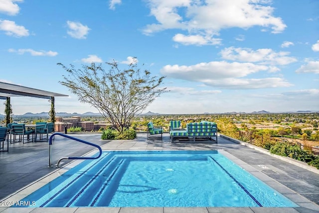 view of swimming pool featuring a mountain view and a patio