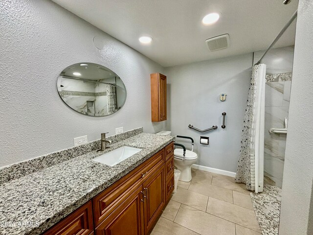 bathroom with toilet, vanity, tile patterned floors, and walk in shower