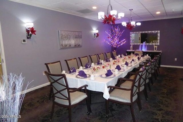 dining room featuring ornamental molding and an inviting chandelier