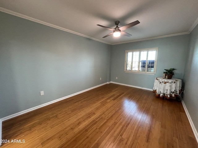 spare room featuring crown molding, dark hardwood / wood-style flooring, and ceiling fan