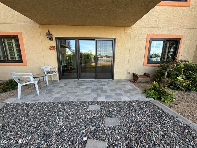 doorway to property with a patio area