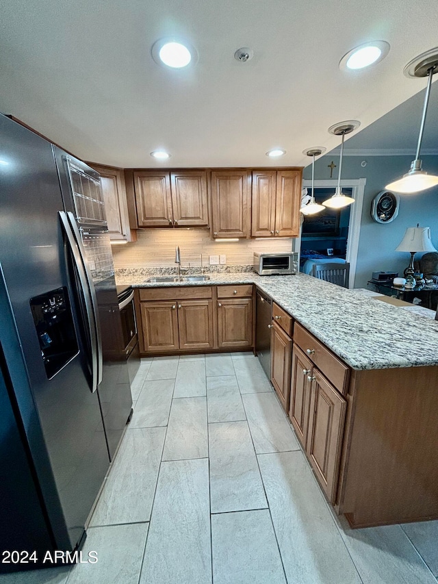 kitchen featuring hanging light fixtures, sink, crown molding, appliances with stainless steel finishes, and light stone counters