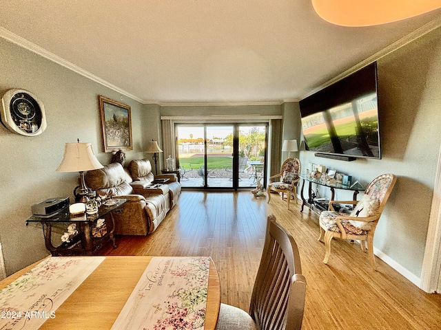 living room with hardwood / wood-style floors and crown molding