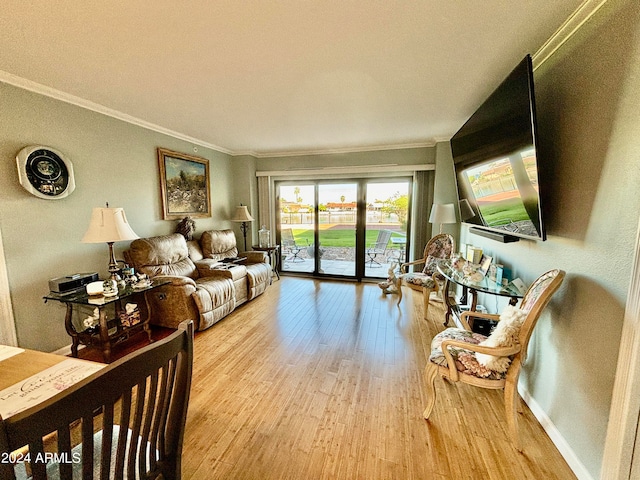 living room featuring crown molding and light wood-type flooring